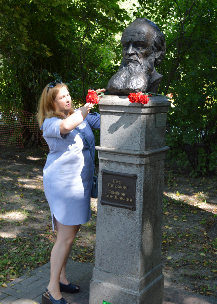 Действительный член РГО, учитель географии Ирина Назаренко возлагает цветы к бюсту П. П. Семёнова-Тян-Шанского