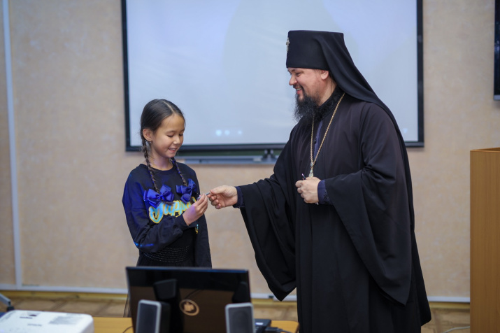 Владыка Ефрем вручает поощрительный приз Софии. Фото: Лидия Чурилина