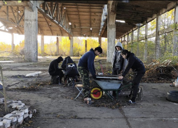 Members of the expedition in search of letters sift through the soil in the hangar of the former German Neutief Airfield. Photo: Andrey Ivanov