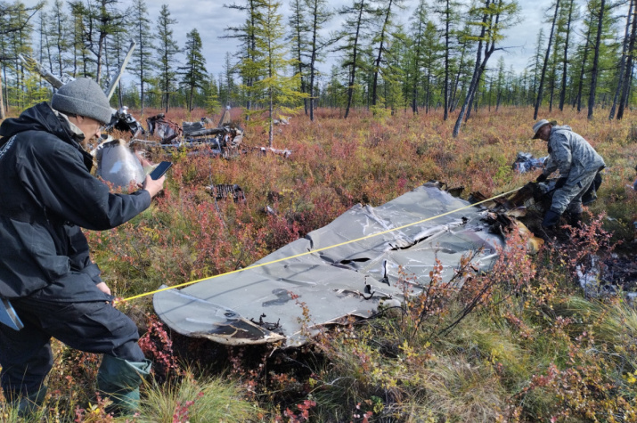 Members of the RGS’s expedition study the wreckage of the aircraft on the ALSIB Air Route. Photo: Pavel Filin